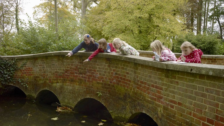 Children on a bridge in the garden at Mottisfont, Hampshire